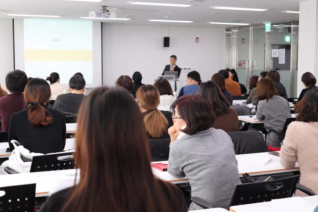A group of people listening to a presentation