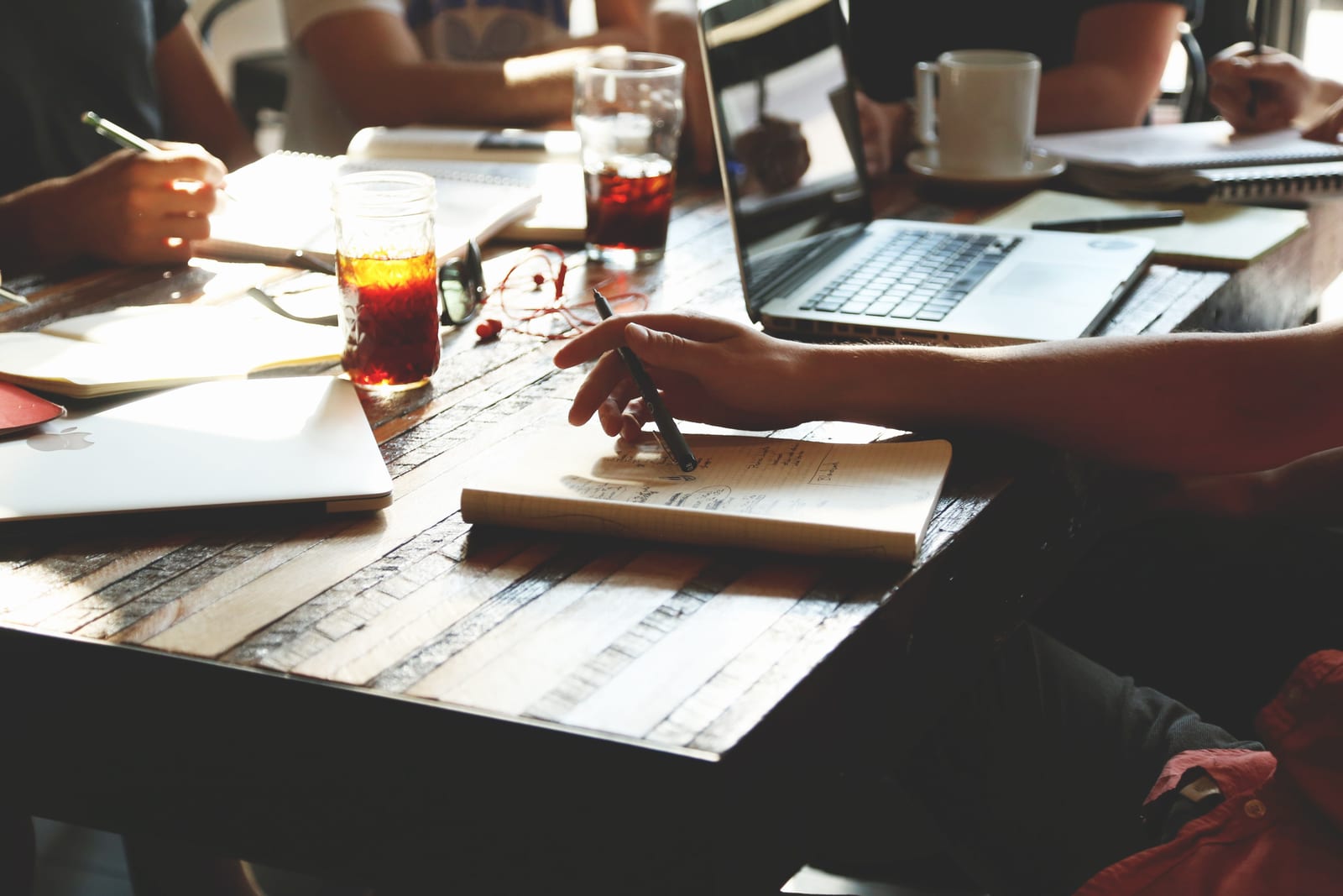 Small business owner reviewing a social media content calendar on a laptop with her social media manager